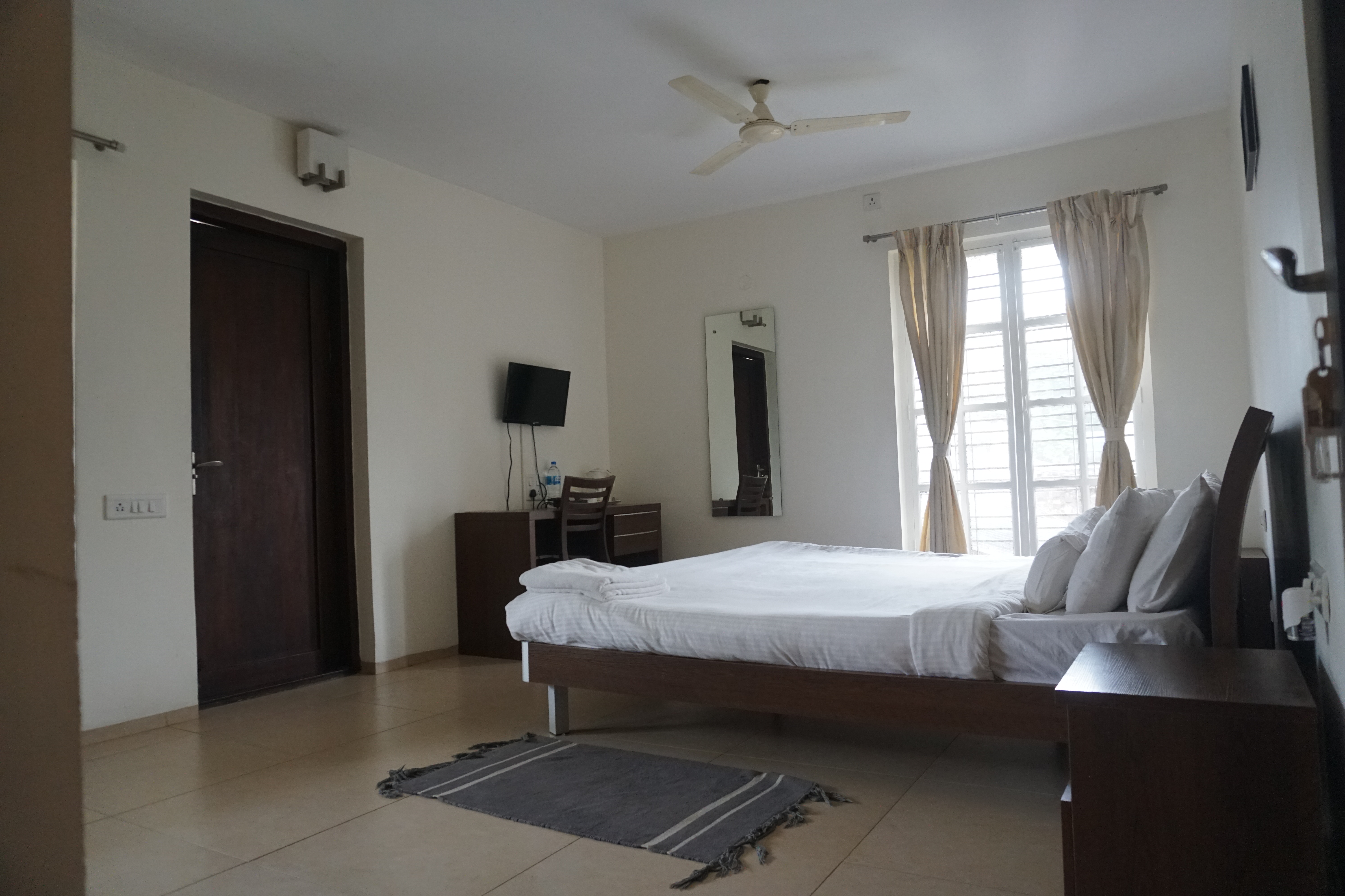 Bedroom with elegant décor at Oleander Suites Coorg